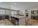 Modern kitchen with granite countertops, a breakfast bar, stainless appliances, and seamless flow into other living spaces at 6302 E Turquoise Ave, Paradise Valley, AZ 85253