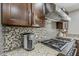Close up of the kitchen features including a stainless steel range and tile backsplash at 6302 E Turquoise Ave, Paradise Valley, AZ 85253
