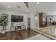 Bright and airy living room with stylish furniture, a large TV, and seamless flow into the adjacent kitchen area at 6302 E Turquoise Ave, Paradise Valley, AZ 85253