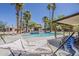 Outdoor pool featuring palm trees, cabana, and a patio with a hammock at 6302 E Turquoise Ave, Paradise Valley, AZ 85253