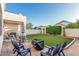 The backyard has a cozy gathering spot with an artificial lawn and a covered seating area, perfect for outdoor activities at 6846 S 26Th Pl, Phoenix, AZ 85042