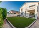 Beautiful backyard featuring an artificial lawn, covered patio, and great backyard seating at 6846 S 26Th Pl, Phoenix, AZ 85042