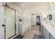 Bright bathroom with large mirror, walk-in shower, bathtub, and neutral tile flooring at 6846 S 26Th Pl, Phoenix, AZ 85042
