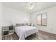 Bright bedroom with wood-look flooring, a ceiling fan, and a dedicated desk area at 6846 S 26Th Pl, Phoenix, AZ 85042