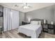 This bedroom features wood-look floors, a ceiling fan, and a neutral color scheme at 6846 S 26Th Pl, Phoenix, AZ 85042