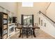 Dining area with farmhouse table, view to backyard, and stairs to the second floor at 6846 S 26Th Pl, Phoenix, AZ 85042