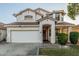 Charming two-story home featuring a white stucco exterior, a tile roof, and a well-maintained front yard with mature landscaping at 6846 S 26Th Pl, Phoenix, AZ 85042