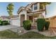Charming two-story home featuring a white stucco exterior, a tile roof, and a well-maintained front yard with mature landscaping at 6846 S 26Th Pl, Phoenix, AZ 85042