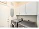 Well-equipped laundry room features modern washer and dryer, ample storage, and functional ironing station at 6846 S 26Th Pl, Phoenix, AZ 85042