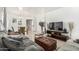 Open-concept living room featuring modern decor, a large TV, and views of the dining area at 6846 S 26Th Pl, Phoenix, AZ 85042