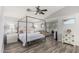 Spacious main bedroom featuring a four-poster bed frame, wood floors, and a seating area with large windows at 6846 S 26Th Pl, Phoenix, AZ 85042