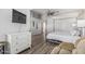 Bedroom with wood floors, TV, modern décor, and a four-poster bed; door leads to other rooms at 6846 S 26Th Pl, Phoenix, AZ 85042