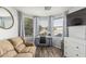 Sitting area off the main bedroom featuring a comfortable couch, desk by the window, and wood floors at 6846 S 26Th Pl, Phoenix, AZ 85042