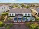 Stunning aerial shot of backyard oasis featuring a pool, spa, and covered patio with manicured landscaping at 7511 S Parkcrest St, Gilbert, AZ 85298