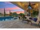 Beautiful backyard oasis with a sparkling pool and comfortable seating area, perfect for entertaining at 7511 S Parkcrest St, Gilbert, AZ 85298