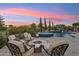 Backyard featuring a pool, spa, fire pit, and beautiful landscaping for ultimate outdoor living at 7511 S Parkcrest St, Gilbert, AZ 85298