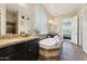 Elegant bathroom with a soaking tub, tile floors, granite counters, and double sinks at 7511 S Parkcrest St, Gilbert, AZ 85298