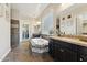 Luxurious bathroom with a soaking tub, tile floors, granite counters, and custom cabinetry at 7511 S Parkcrest St, Gilbert, AZ 85298