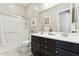 Bathroom with double sink vanity, tile floors, and a walk-in shower with glass doors at 7511 S Parkcrest St, Gilbert, AZ 85298