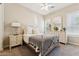 Cozy bedroom featuring neutral walls, a bed with soft bedding, and white dresser with mirror at 7511 S Parkcrest St, Gilbert, AZ 85298