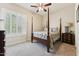 Bedroom featuring a four poster bed, shutters on the windows, and a ceiling fan at 7511 S Parkcrest St, Gilbert, AZ 85298