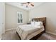 Bedroom featuring soft carpet, neutral walls, a bed with soft bedding, and plantation shutters at 7511 S Parkcrest St, Gilbert, AZ 85298