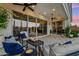Inviting covered patio with comfortable seating, string lights, and view of the backyard at 7511 S Parkcrest St, Gilbert, AZ 85298