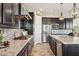 Modern kitchen featuring granite countertops, dark cabinetry, and stainless steel appliances at 7511 S Parkcrest St, Gilbert, AZ 85298