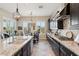 Elegant kitchen featuring dark cabinets, granite countertops, and stainless steel appliances at 7511 S Parkcrest St, Gilbert, AZ 85298