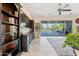 Bright living room with built-in bookcase, entertainment center, and a view of the outdoor pool at 7511 S Parkcrest St, Gilbert, AZ 85298