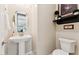 Charming powder room with pedestal sink, oval mirror, and elegant décor at 7511 S Parkcrest St, Gilbert, AZ 85298