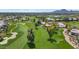 Aerial view of a golf course surrounded by trees and residential properties at 7710 E Gainey Ranch Rd # 206, Scottsdale, AZ 85258