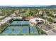 Aerial view of a community with a clubhouse, tennis courts, and manicured lawns providing a luxurious lifestyle at 7710 E Gainey Ranch Rd # 206, Scottsdale, AZ 85258