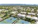 Charming community aerial with lush landscaping, mature trees, and tennis courts offering an active lifestyle at 7710 E Gainey Ranch Rd # 206, Scottsdale, AZ 85258