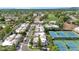 Picturesque aerial view featuring lush landscaping, tennis courts, and charming homes in a vibrant neighborhood at 7710 E Gainey Ranch Rd # 206, Scottsdale, AZ 85258