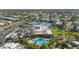 Aerial view featuring lush landscaping, mature trees, pool, and tennis courts at 7710 E Gainey Ranch Rd # 206, Scottsdale, AZ 85258