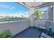 Relaxing balcony with comfortable seating and views of the community tennis courts at 7710 E Gainey Ranch Rd # 206, Scottsdale, AZ 85258