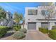 Modern home exterior with a two-car garage, landscaped front yard, and contemporary design at 7710 E Gainey Ranch Rd # 206, Scottsdale, AZ 85258
