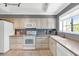 Charming kitchen with white appliances, ample cabinet space, and bright natural light at 7710 E Gainey Ranch Rd # 206, Scottsdale, AZ 85258