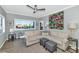 Comfortable living room with large windows, a ceiling fan, and stylish decor at 7710 E Gainey Ranch Rd # 206, Scottsdale, AZ 85258