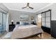 Calm main bedroom with neutral walls, sliding glass doors, and attached bathroom at 7710 E Gainey Ranch Rd # 206, Scottsdale, AZ 85258