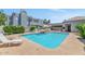 Inviting community pool area featuring lounge chairs and umbrellas for relaxing by the sparkling water at 7710 E Gainey Ranch Rd # 206, Scottsdale, AZ 85258