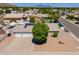 Expansive aerial view of a single-Gathering home featuring a two-car garage, solar panels, and a lush front yard at 823 N 81St St, Mesa, AZ 85207