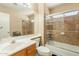Bathroom featuring tiled shower with glass doors, vanity, and large mirror at 823 N 81St St, Mesa, AZ 85207