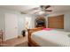 Cozy bedroom with a ceiling fan, a bed with white linens and a classic wood bed frame at 823 N 81St St, Mesa, AZ 85207