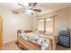 Bedroom features a bed with decorative quilt and neutral carpet at 823 N 81St St, Mesa, AZ 85207