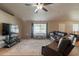 Well-lit living room featuring a large television, comfortable furniture, and a view of the dining area at 823 N 81St St, Mesa, AZ 85207