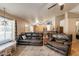 Inviting living room with a comfortable leather sofa and a view towards the kitchen and dining area at 823 N 81St St, Mesa, AZ 85207