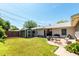 Well-maintained backyard features a lush lawn, storage shed, mature trees, and patio furniture at 840 E 2Nd St, Mesa, AZ 85203
