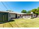 Expansive backyard featuring a lush lawn, mature trees, patio area and a storage shed at 840 E 2Nd St, Mesa, AZ 85203